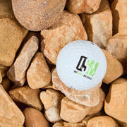 White golf ball with a logo on a bed of brown stones