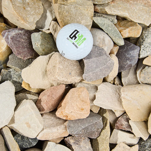 White ball with a logo embedded in a pile of multicolored stones