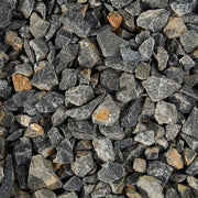 Close-up of small stones and pebbles with a mix of gray, black, and brown colors.
