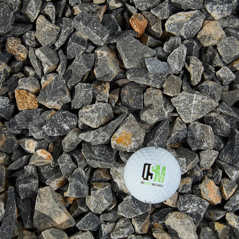 Close-up of dark gray stones with a small circular label featuring 'OSM' branding.
