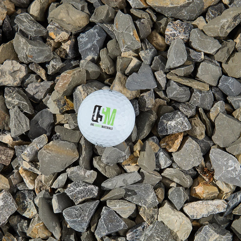 White ball with a logo on a bed of small stones