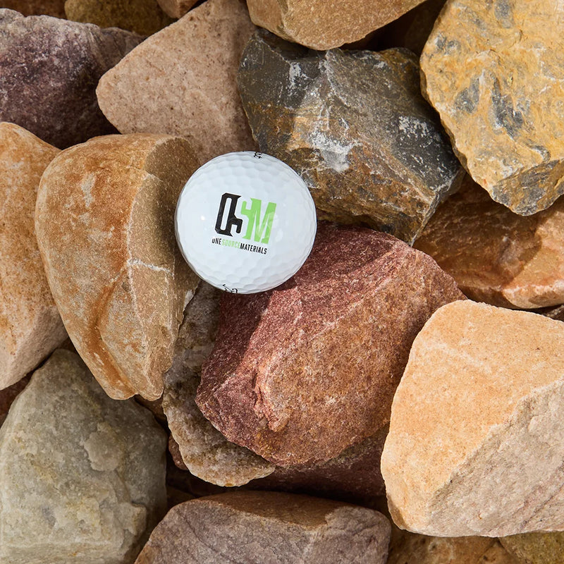 White ball with a logo on it surrounded by assorted rocks