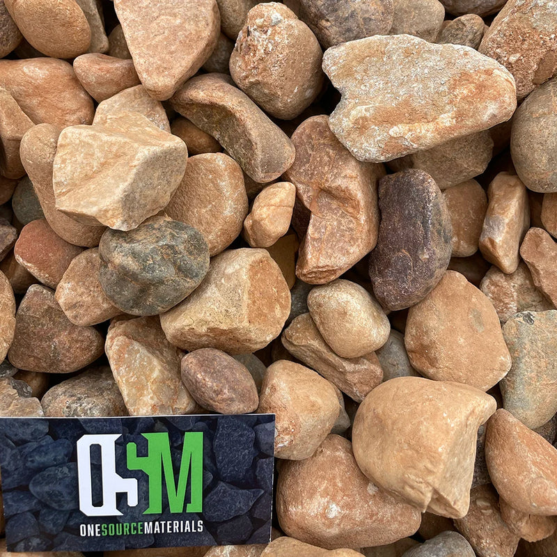 Close-up of assorted colored stones with OneSource Materials business card.