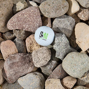 White golf ball with the OSM logo on a bed of stones
