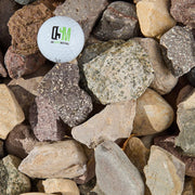 Golf ball with a logo on a bed of rocks