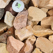 Golf ball with a logo on a bed of stones