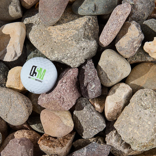 White ball with a logo on a bed of  multicolored rocks