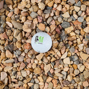 Color sample ball with 'OSM' logo on a bed of 3/8 inch multicolored stones