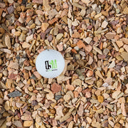 Small white ball with a logo on a bed of multicolored gravel