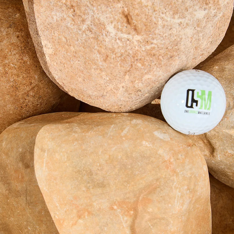 White golf ball with a logo on stones