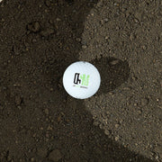 Golf ball with the OSM logo on black lava fines