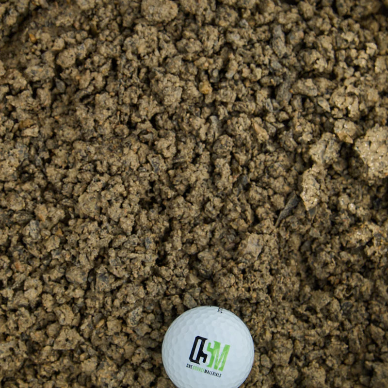 Golf ball on top of brown fines