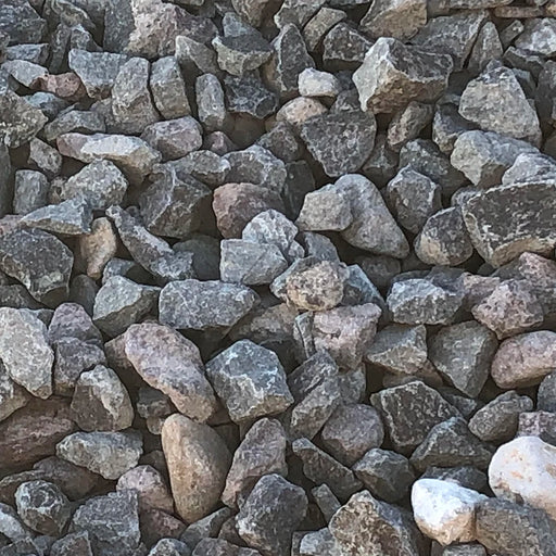 Close-up of small crushed stones and pebbles in various shades of gray and brown.