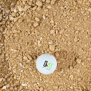 Golf ball with OSM logo sits on Honeycomb crusher fines 