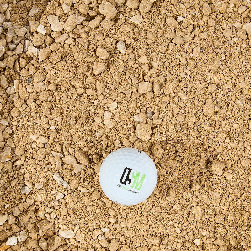 Golf ball with OSM logo sits on Honeycomb crusher fines 