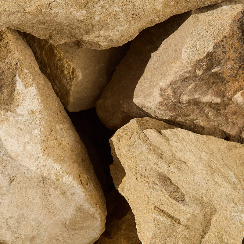 Close-up of large beige stones with shadows