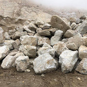 Pile of Island Storm boulders on a mountainous terrain with fog in the background