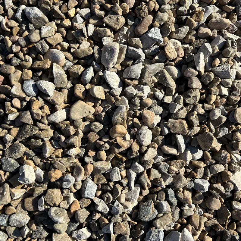 Close-up of small pebbles in various shades of brown, gray, and white.