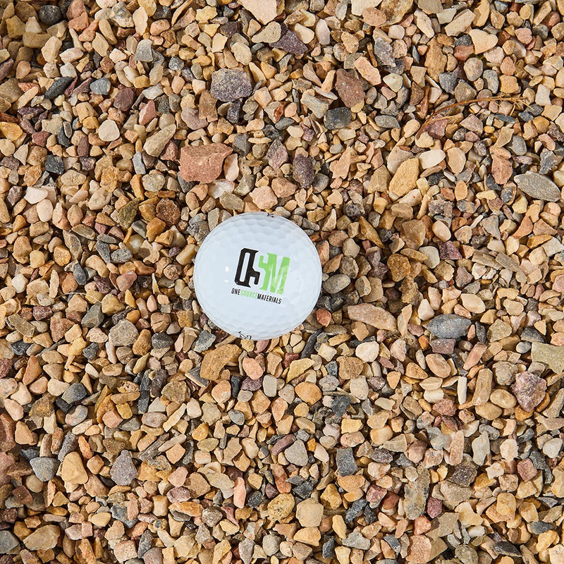 Small white ball with a logo on a bed of multicolored stones