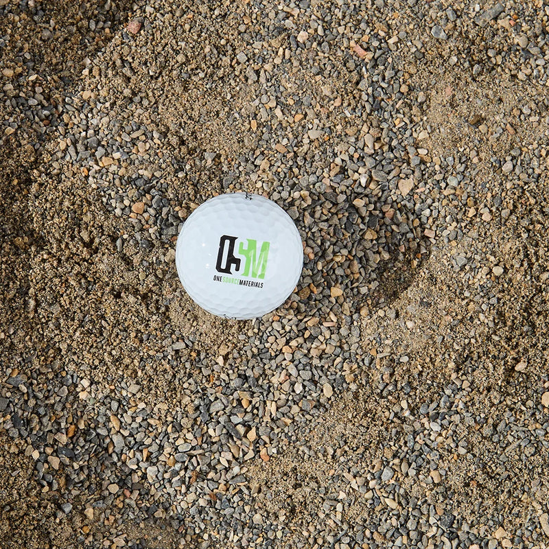 Golf ball with a logo on a gravel surface